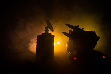 Creative artwork decoration. Silhouette of mobile air defence truck with radar antenna during...