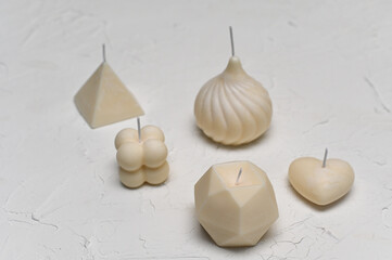 handmade candles. beautiful scented candles on a white plastered background.
