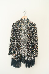 beautiful leopard print shirt hanging on wall