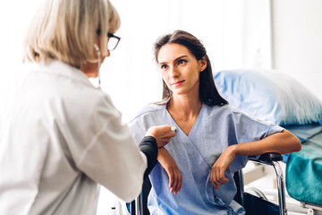 Fototapeta premium Senior woman doctor wearing uniform with stethoscope service help support discussing and consulting talk to sick woman patient about checkup result information in hospital