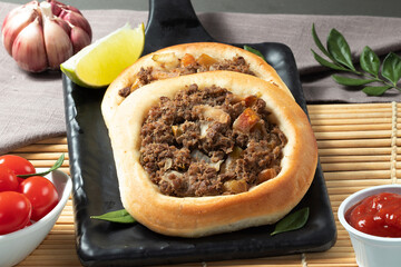 Traditional meat sfiha with sauce.