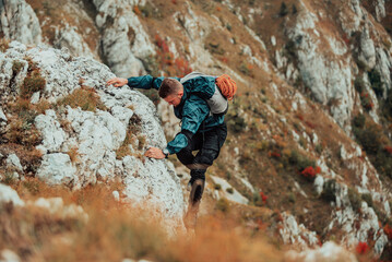 A male climber climbing up on the mountain rock adventure travel extreme sport outdoor.
