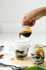 Pour Liquid Palm Sugar to the Glass with Green Grass Jelly Drink or Cingcau Hijau.
