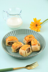 Puff Pastry Roll with Sausage and Cheese on Top