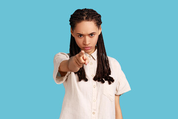Serious strict woman with black dreadlocks looking attentively at camera, pointing directly at...