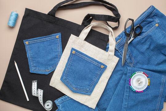 Old jeans and fabric bag with sewing accessories. Top view. Recycling concept. Crafting with denim.