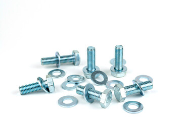 several metal bolts with washers and nuts on a white background. close-up