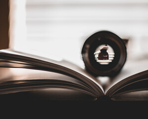 PEERING THROUGH CAMERA LENS ON BOOK 
