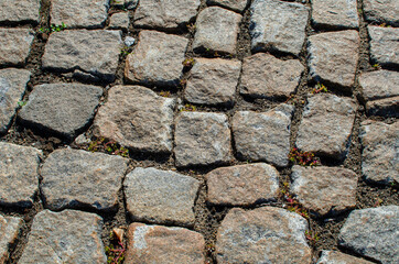 abstract background. pavement in the city park made of granite stones