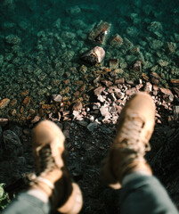 HANGING FEET OVER CLIFF AND ROCKS