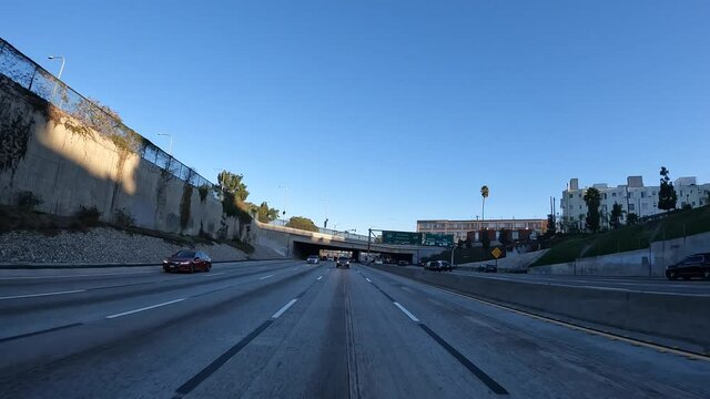 Driving along a highway in Los Angeles, California while looking out the rear window