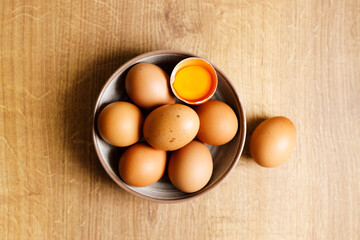 brown eggs in a bowl on wooden table..