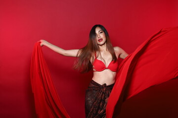 Fototapeta premium Young Slim Transgender Asian Woman wears red bikini bra dress, Beautiful Girl fluttering fabric