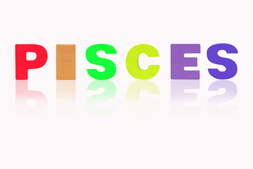 PISCES is in (12 Zodiac) isolated on white background. Colorful wooded alphabets set sort. English letter made of wood arrange alphabet as categorize suitable for children. Poster, banner design. 