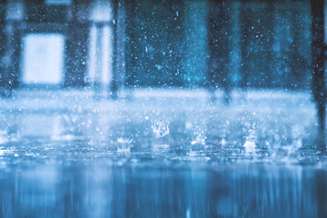 Naklejka na ściany i meble heavy raining make many small splash crown from water droplets drop down to the concrete floor in blue tone color scene