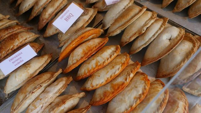Rows of empanadas, national Spanish dish. Baked turnovers.