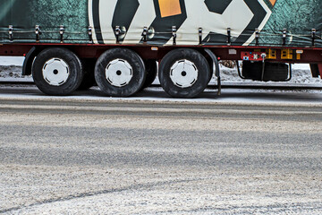 Rear wheels of a truck on a winter day close-up