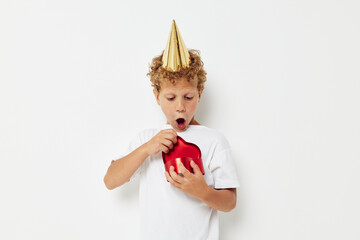 little boy wearing a white t-shirt with a cap on his head birthday gift