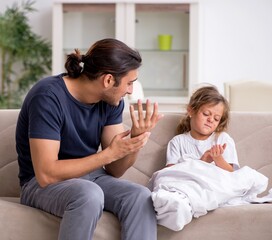 Father taking care of his ill daughter