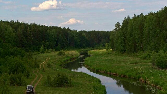 Aerial view of a car on the river bank
