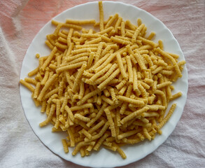 Raw homemade Passatelli. Traditional Italian pasta usually cooked in broth. View from above