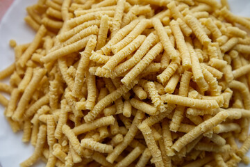 Raw homemade Passatelli. Traditional Italian pasta usually cooked in broth. Close up