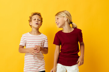 Portrait of cute children casual wear games fun together on colored background