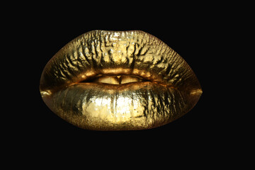 Gold lips. Gold paint from the mouth. Golden lips on woman mouth with make-up. Sensual and creative design for golden metallic. Golden lip texture.