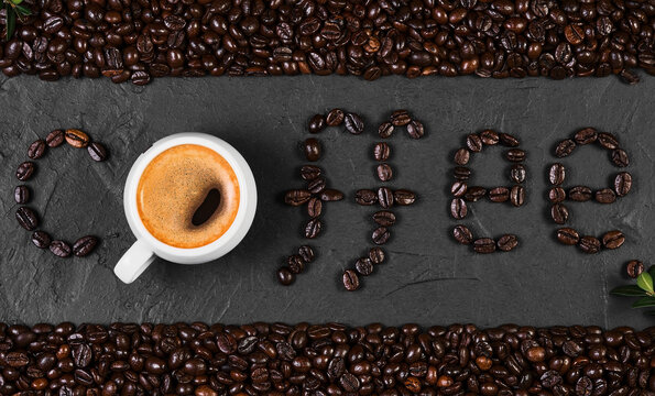 Coffee background, arrangement of freshly roasted coffee beans on a black table and a cup of espresso coffee, coffee advertising idea. © Ed