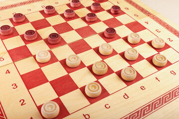 Chess board with checkers during game close up.