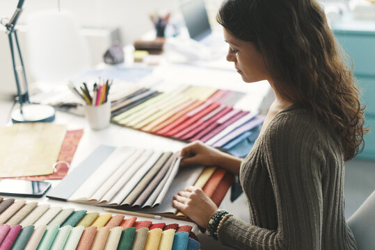 Young interior designer choosing fabric samples