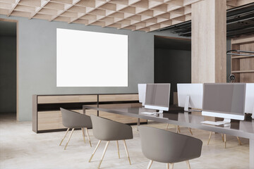 Modern concrete and wooden coworking office interior with blank mock up banner on wall, empty computer screens, equipment, furniture and daylight. 3D Rendering.