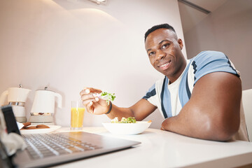 Man smiling while eating lunch at home