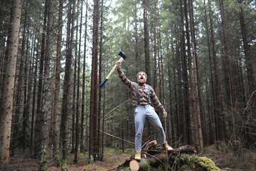 Fototapeta na wymiar A bearded lumberjack with a large ax