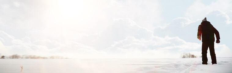 A man on a walk. Winter landscape. Tourist in winter journey.
