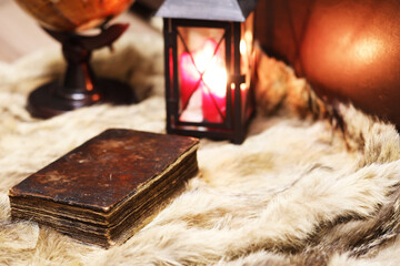 Retro old book and world desk globe on fur, learning and education concepts.