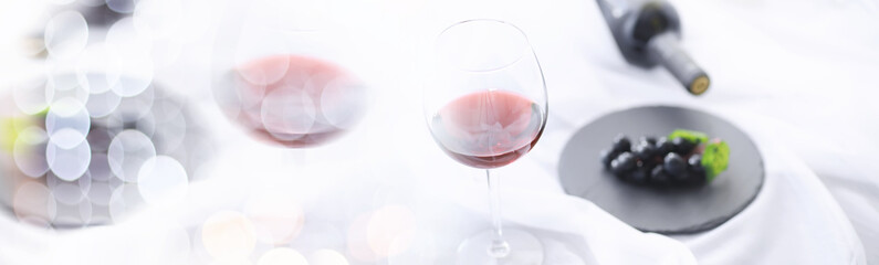 Glass with grape red semi-dry wine. Valentine's day concept background. Gift for the holiday. Sweet sparkling wine.