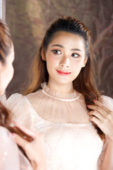 Half body Portrait of 20s Fashion Asian Woman honey skin has beautiful brown hair style. Girl wears