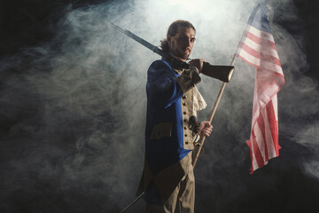 American revolution war soldier with flag of colonies and musket gun over dramatic smoke background. 4 July independence day of USA concept photo composition: soldier and flag. - 480883947