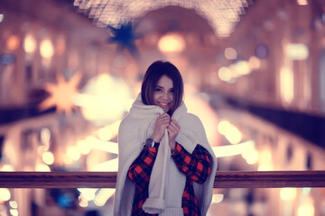 Fototapeta premium portrait of a woman white sweater winter, seasonal outside city walk in the evening city