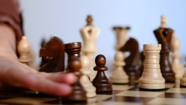 unrecognizable woman playing chess. strategy, management or leadership concept. slow motion video.