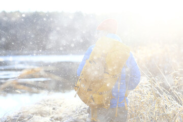 winter landscape man with a backpack / nature landscape a man on a hike with equipment in snowy weather in Canada