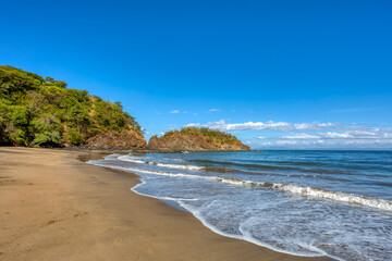 pacific ocean waves on Playa Ocotal, El Coco Costa Rica. Famous snorkel beach. Picturesque paradise tropical landscape of Costa Rica beach. Pura Vida concept, travel to exotic tropical country.