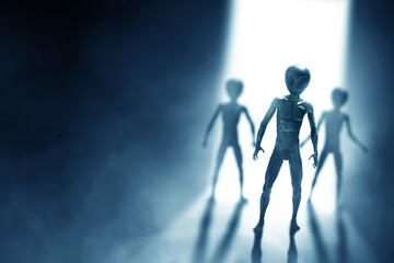 Silhouettes of aliens creature on dark background.