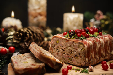 Fototapeta na wymiar Traditional French terrine covered with bacon and Christmas decoration on dark wooden background