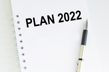 plan 2022 inscription on the notebook on the table, planning the new year, goals and objectives