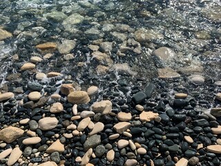 Big sea pebble and transparent water, natural background, sea coast