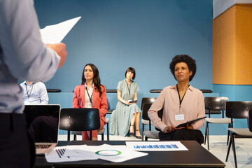 Conference members sitting at safe distance in board room