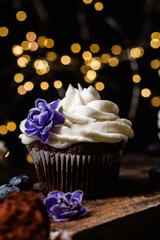 Chocolate cupcakes with blueberries on a dark table
