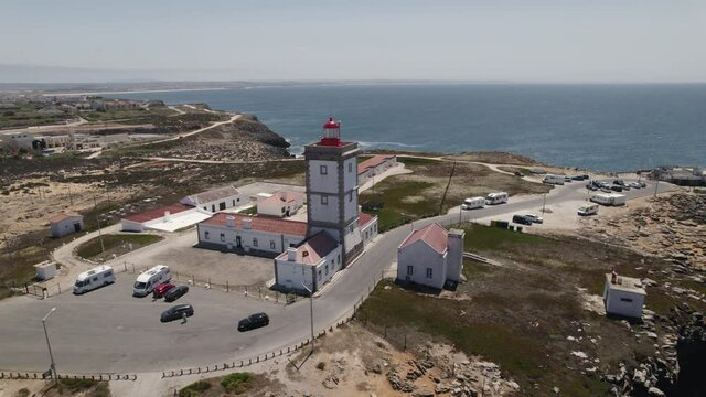 Lighthouse of Cape Carvoeiro in Peniche, sea and coastline of Portugal. Aerial pullback